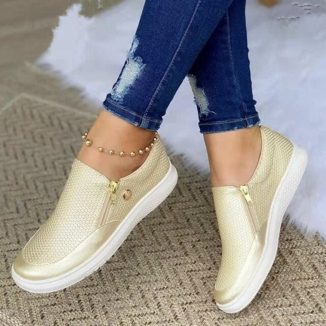 Gold platform slip-on sneakers with textured mesh upper and side zipper