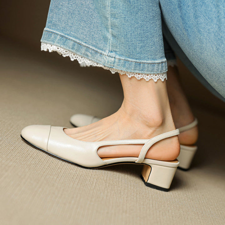Off-white leather slingback pumps worn with cuffed denim jeans side view