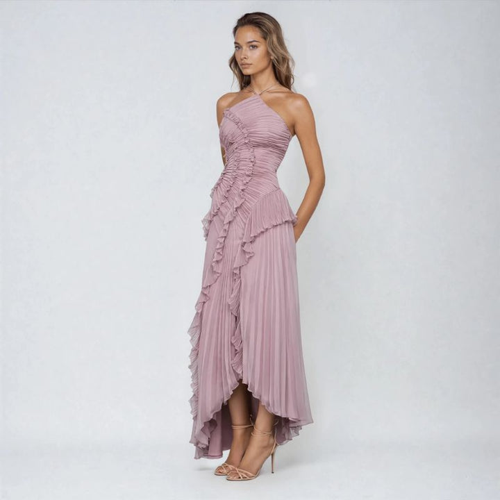 Side view of soft purple asymmetrical halter gown with ruched bodice and ruffle panel