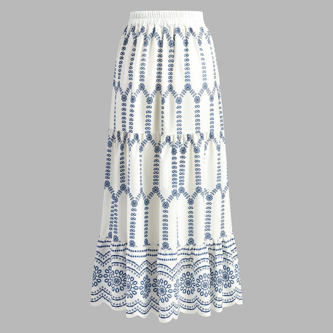 White three-tiered maxi skirt with elastic waist and floral border