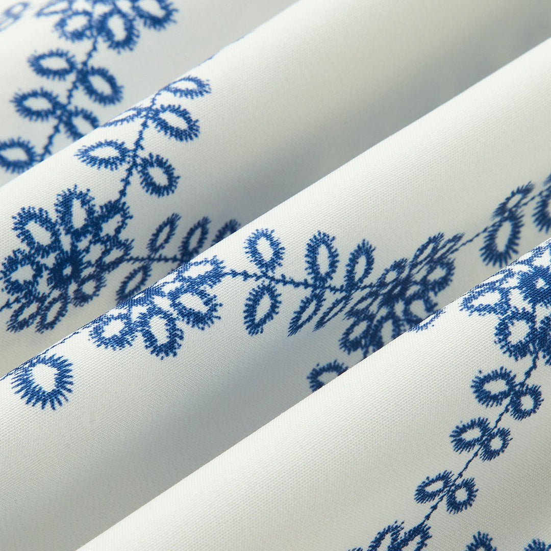 Detailed eyelet embroidery pattern on white summer boho fabric