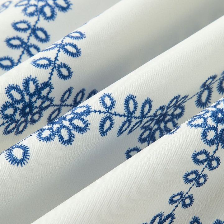 Detailed eyelet embroidery pattern on white summer boho fabric