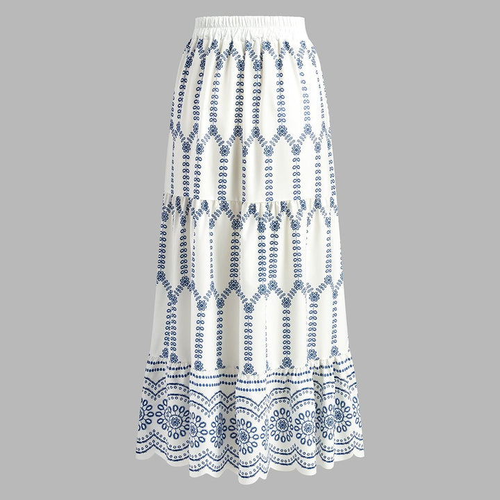 High-waisted white tiered maxi skirt with blue geometric embroidery