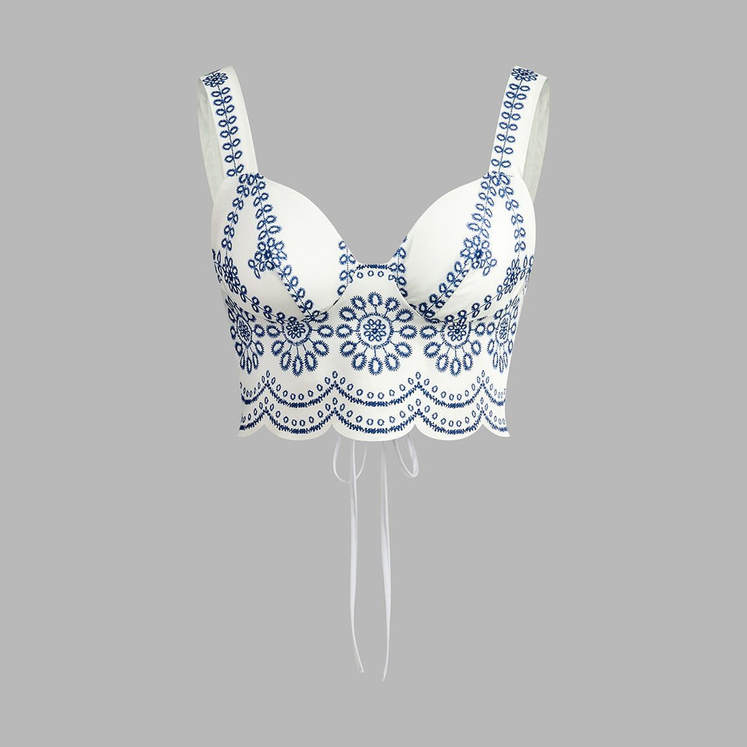White bustier crop top with blue floral embroidery and scalloped hem