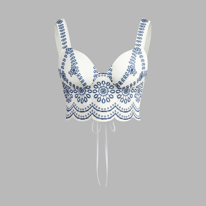 White bustier crop top with blue floral embroidery and scalloped hem