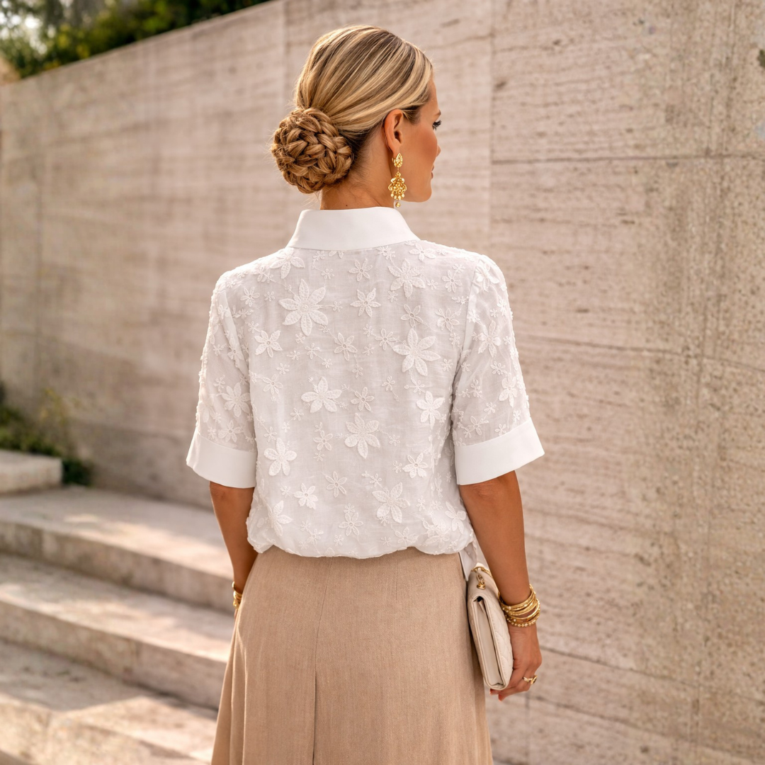 Back view of white floral embroidered women's blouse with loose fit