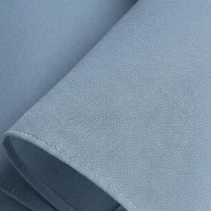 Dusty blue lightweight chiffon fabric swatch with fine weave and straight seam