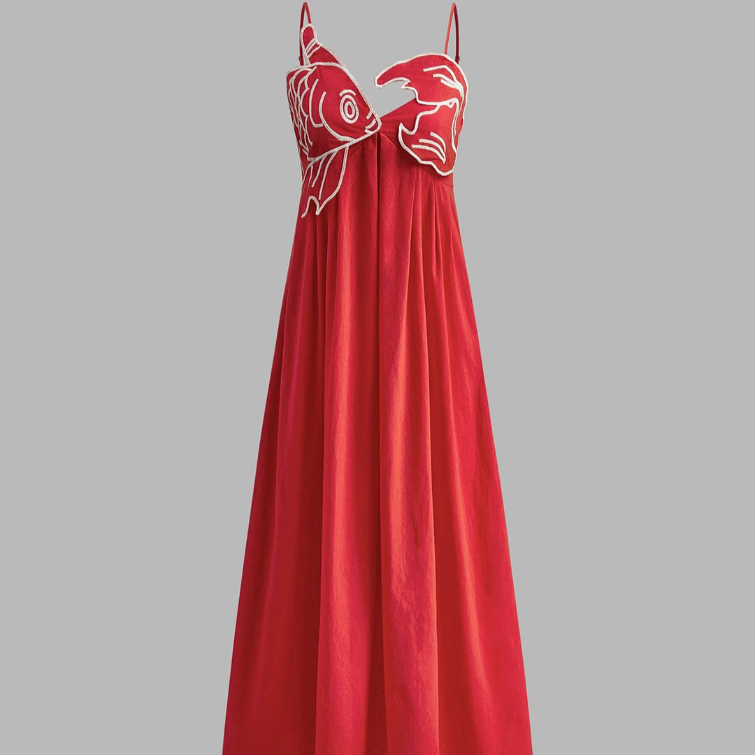 Red spaghetti strap maxi dress featuring dual sculpted fish appliqués and empire waist