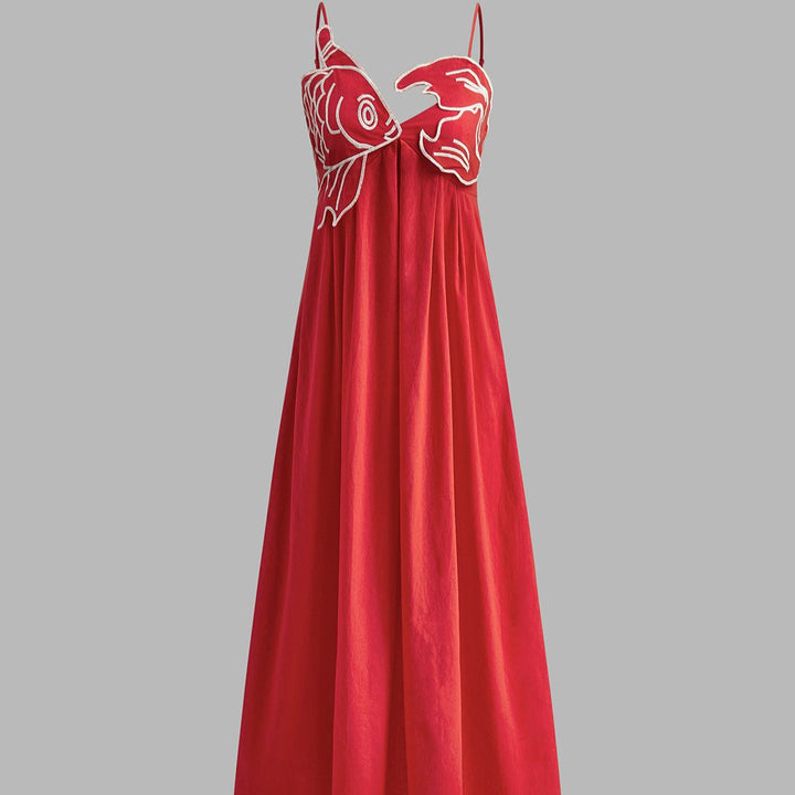Red spaghetti strap maxi dress featuring dual sculpted fish appliqués and empire waist