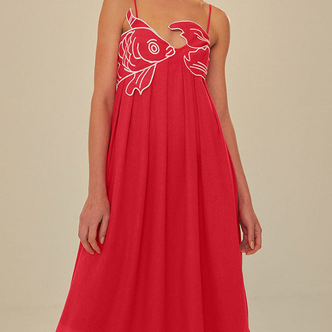 Red sleeveless pleated maxi dress with white outlined fish bodice appliqué on model