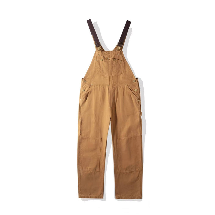 Tan cotton canvas bib overalls flat lay with wide straps and relaxed fit