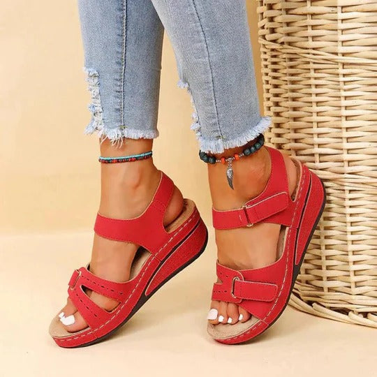 Red multi-strap wedge sandals with visible stitching and open heel for daily wear