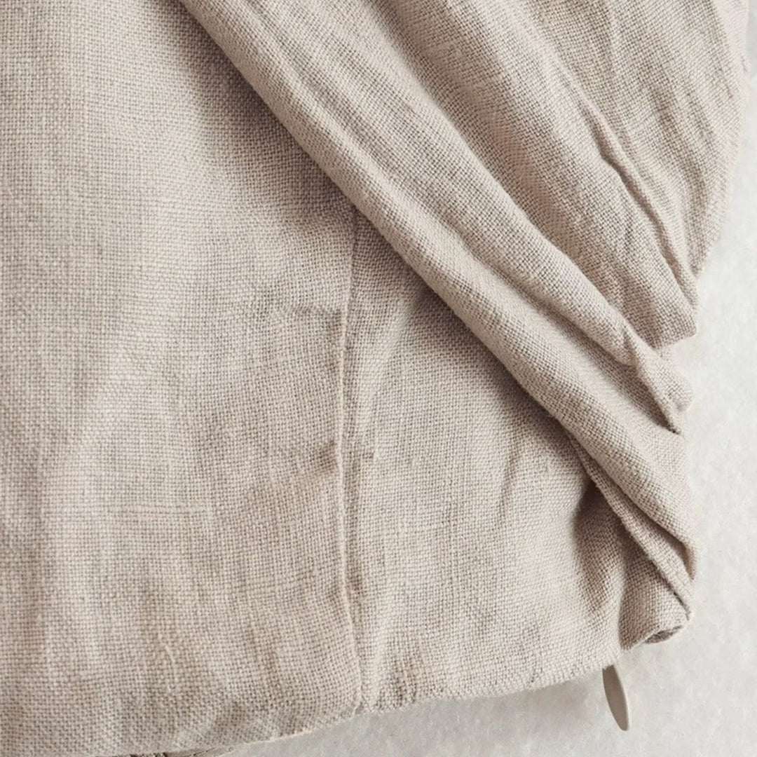 Close-up of textured beige linen-blend fabric weave detail