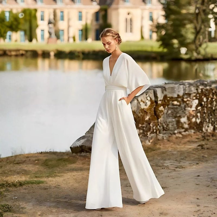 White chiffon women's jumpsuit with flutter sleeves and wide legs for formal garden party or wedding