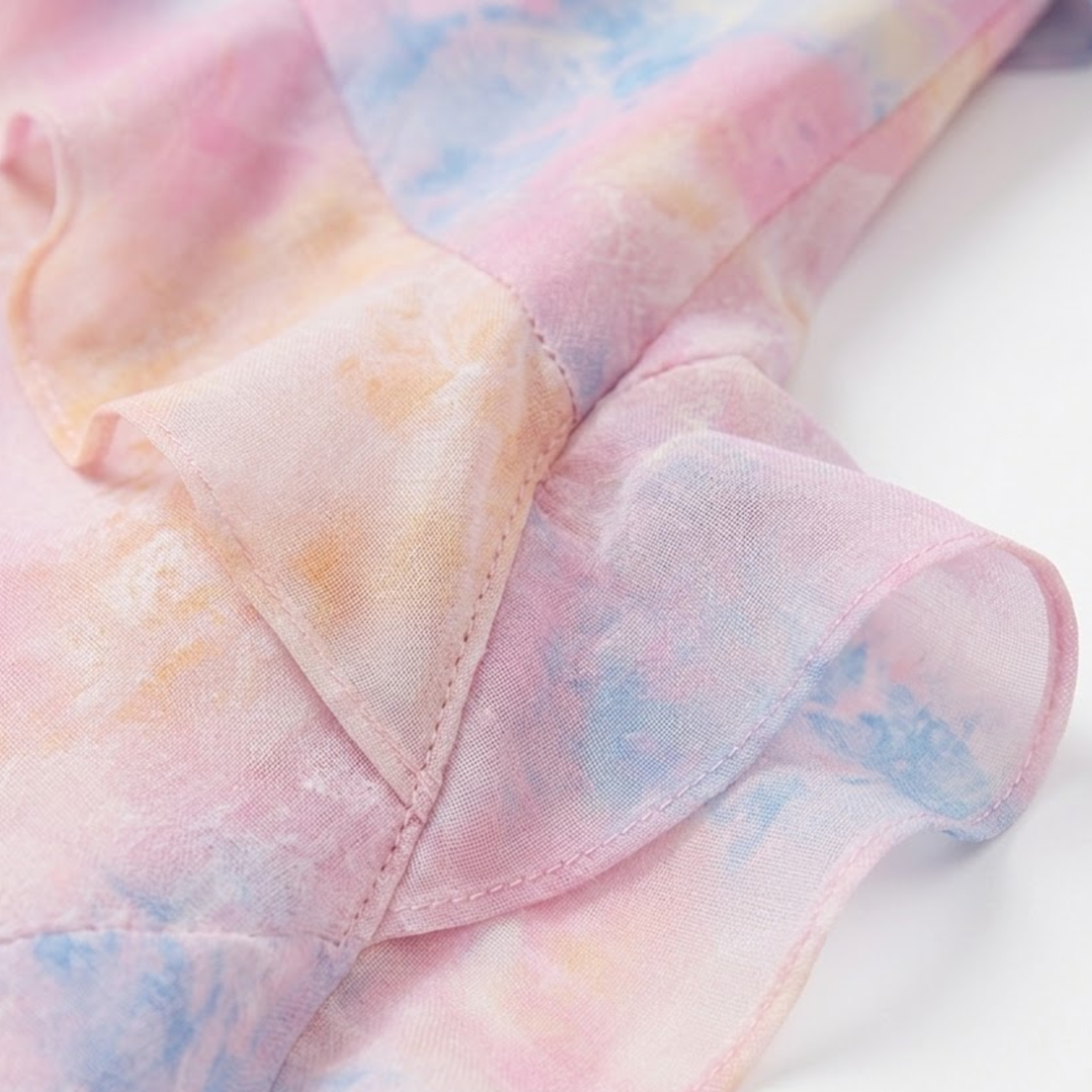 Close-up of lightweight semi-sheer fabric and layered ruffle detail on floral dress